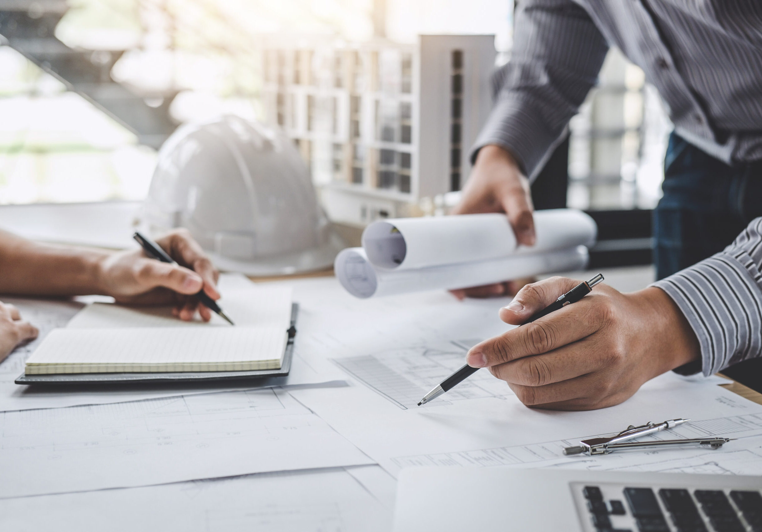 Construction and structure concept of Engineer or architect meeting for project working with partner and engineering tools on model building and blueprint in working site.